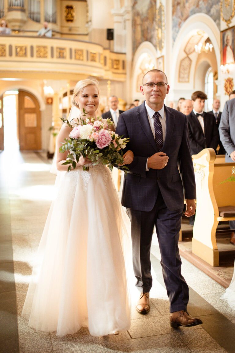Ojciec prowadzi pannę młodą do ołtarza